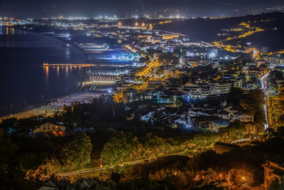 High angle view of illuminated buildings in city at night