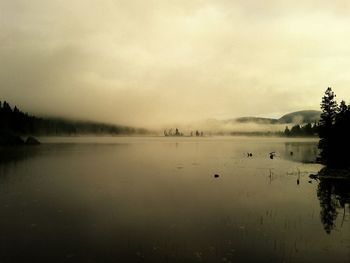 Scenic view of lake during foggy weather