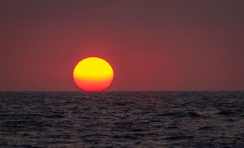 Scenic view of sea against romantic sky at sunset