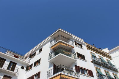 Low angle view of building against clear blue sky