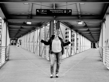 Full length rear view of man standing on escalator