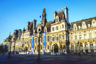 Low angle view of historical building against blue sky