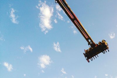 Low angle view of crane against sky