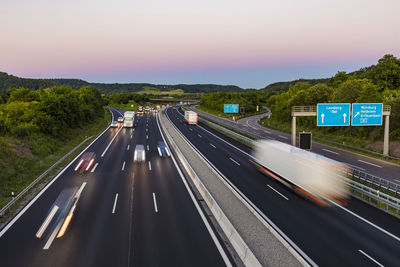 Blurred motion of highway against sky during sunset