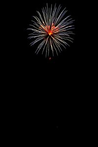 Low angle view of firework display at night