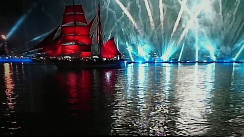 Sailboats in river at night