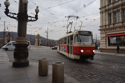 Train on street in city against sky