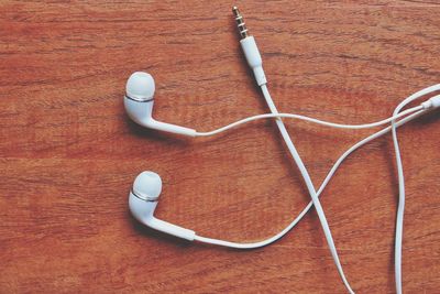 Close-up of headphones on wooden table