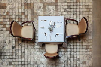 High angle view of table and three chairs