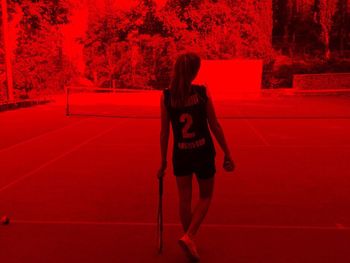 Rear view of woman standing in park