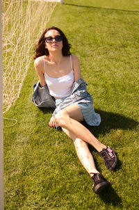 Young woman sitting on field