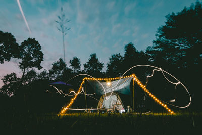 Rear view of man standing by wire wool against sky in nam cat tien forest, dong nai, viet nam