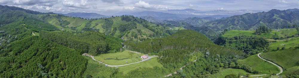 Panoramic view of trees and mountains against sky