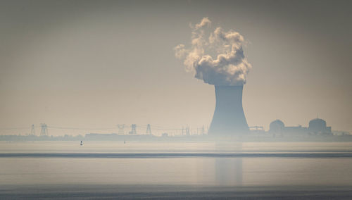 Smoke stack on the delaware river horizon. 