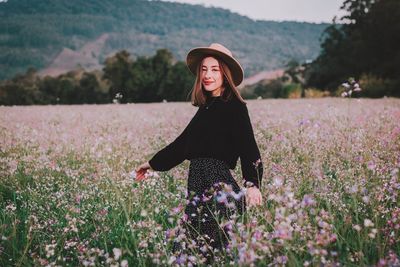 Portrait of woman standing on field