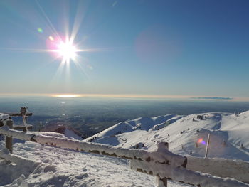 Scenic view of snow covered landscape against sky