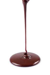 Close-up of wineglass on table against white background