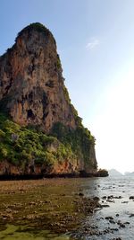 Scenic view of rock formation by sea against sky