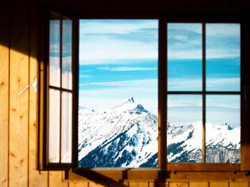 Close-up of snow covered landscape seen through window