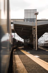 Train at railroad station against sky