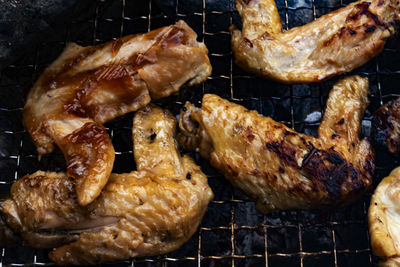 High angle view of meat on barbecue grill