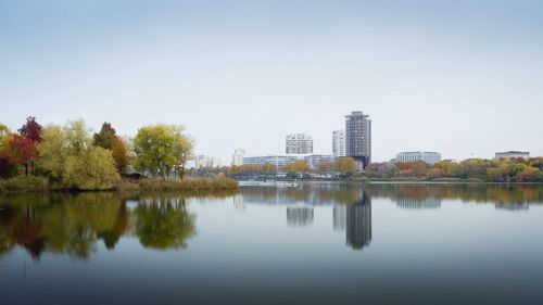 Reflection of trees in lake against clear sky