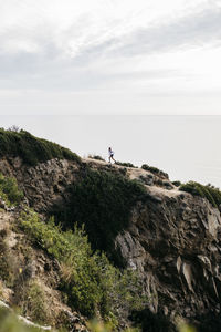 Rock formations by sea against sky