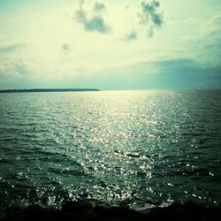 Scenic view of sea against cloudy sky