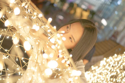 Portrait of woman with illuminated lights