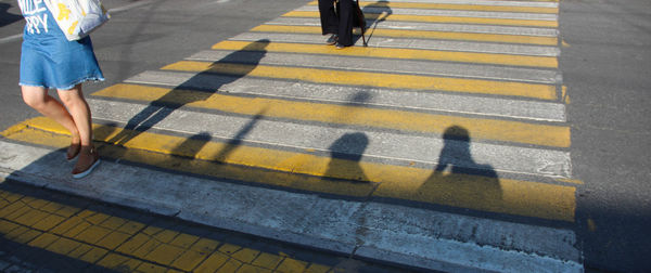 Low section of people walking on road