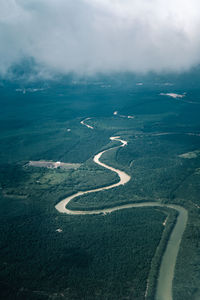 Top view scenery showing perfect natural river, green forest on mountain at sabah.