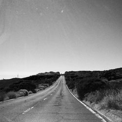 Empty road along trees