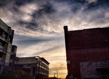 Low angle view of building against cloudy sky