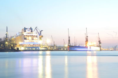 Boats in river with buildings in background