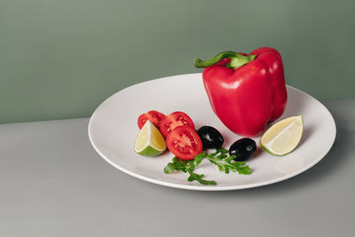 Fresh bell pepper and vegetables on table. red vegetable. creative trendy healthy food for