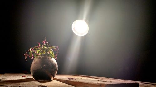 Close-up of illuminated lamp at night