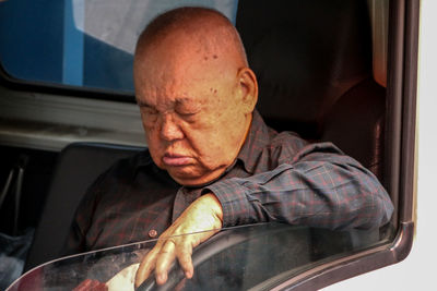 Portrait of man sitting in car