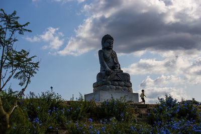 Low angle view of statue against sky