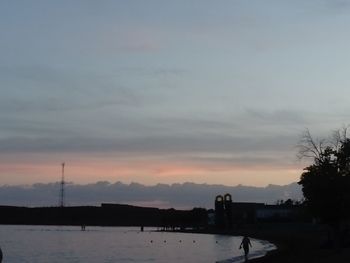 Scenic view of river against sky at sunset