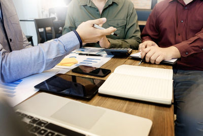 Close-up of people working on table