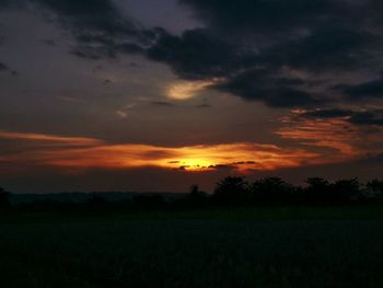 Scenic view of field against sky during sunset