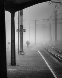 Man walking on railroad track in city