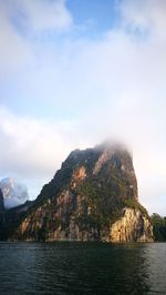 Scenic view of sea and mountains against sky