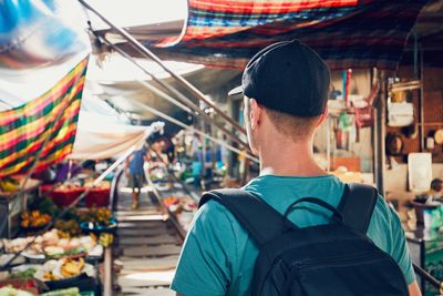 Rear view of man standing at market