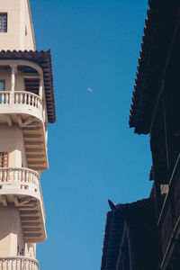 Low angle view of building against clear blue sky