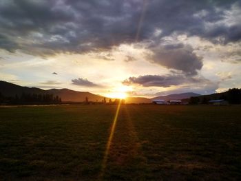 Scenic view of field against sky during sunset