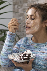 Portrait of young woman holding ice cream