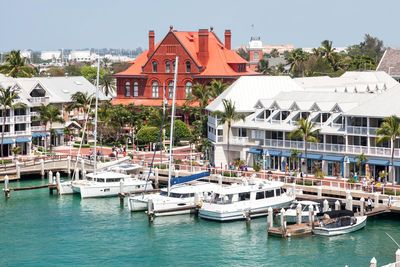 Boats moored in swimming pool against buildings