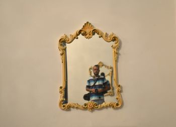 Close-up of cross against wall