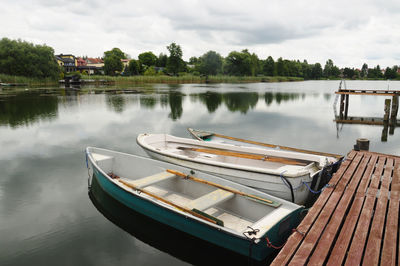High angle view of boats moored by pier over lake